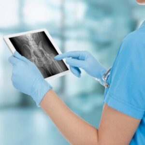 Technician looking at radiograph